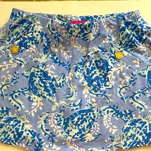 UPF 50+ stretch woven golf skort with front, back and undershort pockets.